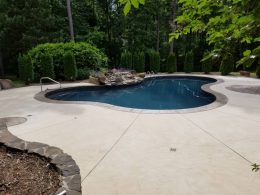 Pool patio with waterfall and slate stamped patio