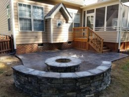 hardscape seat wall and firepit with stamped patio